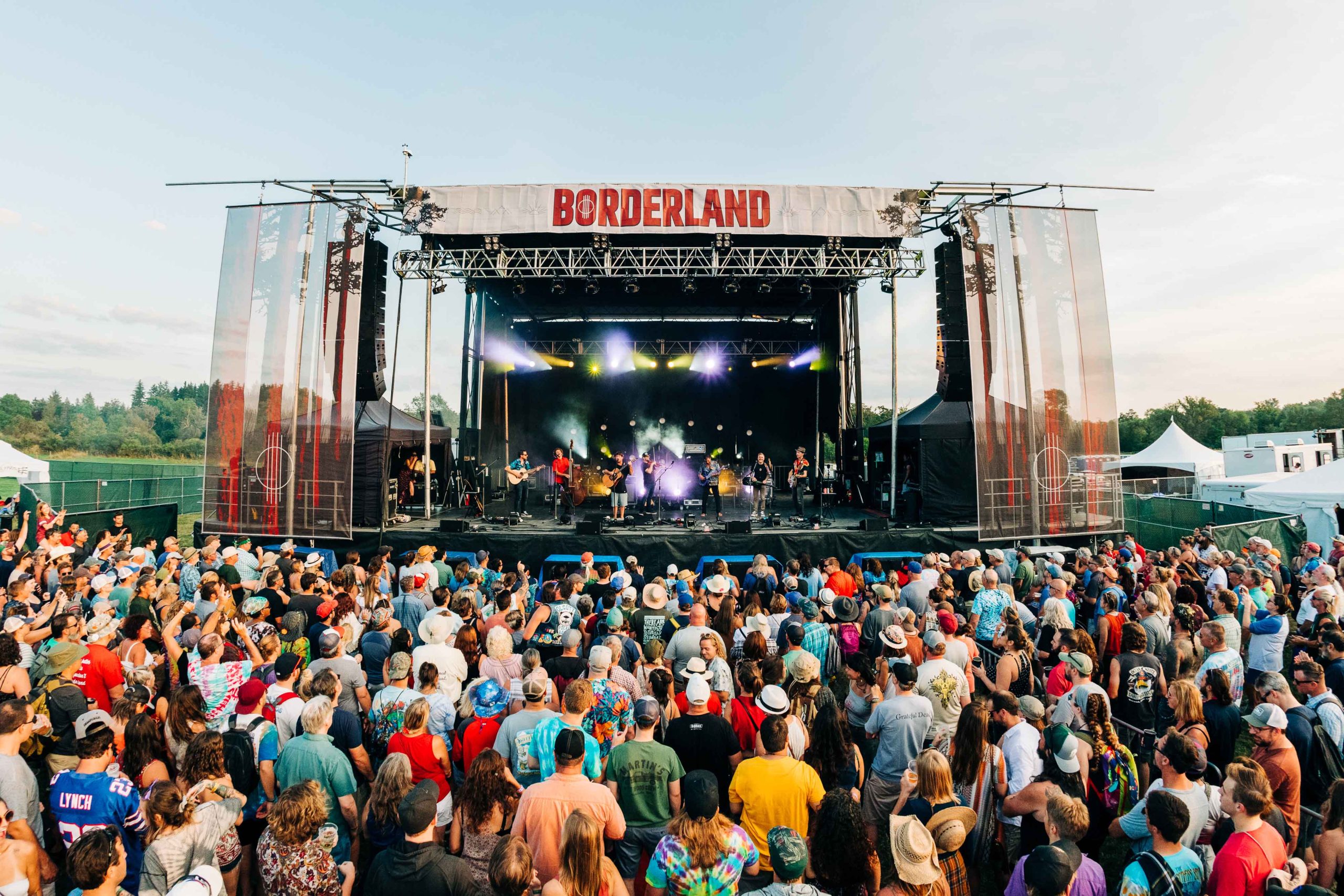 A photo of a large crowd enjoying live music on the main stage of Borderland Music + Arts Festival.